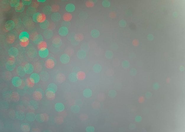 Foto gratuita luce verde del bokeh su sfondo grigio