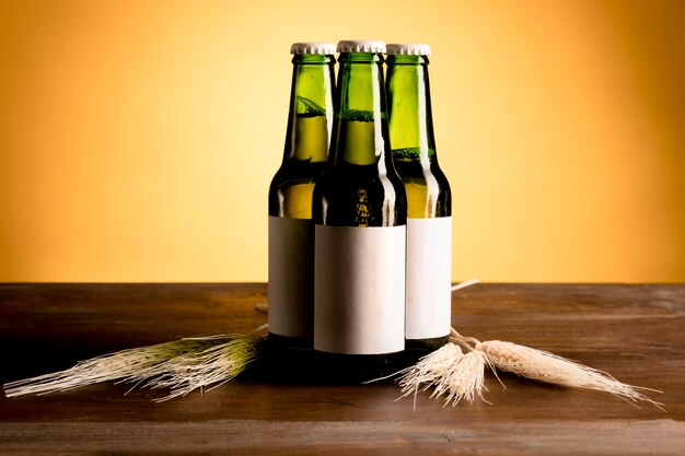 Green bottles of alcohol on wooden table