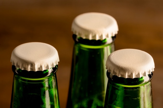 Free photo green bottles of alcoholic drink with white caps