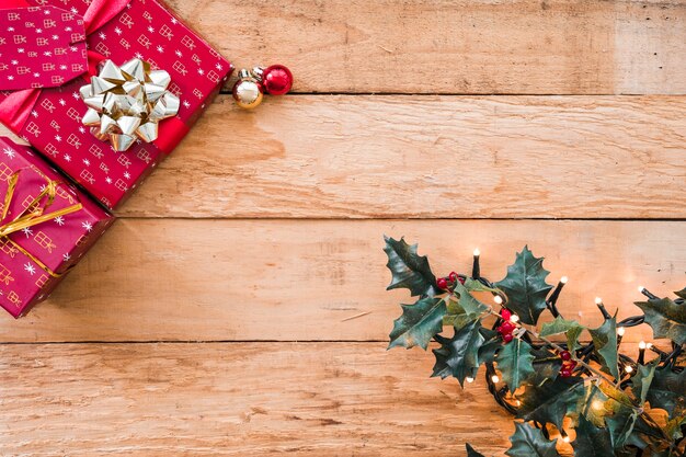 Green branch with fairy lights near present boxes 