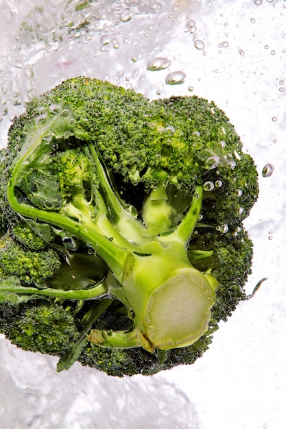 Green broccoli dropped into water