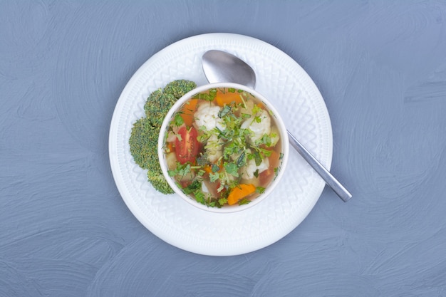 Green broccoli soup in broth with vegetables