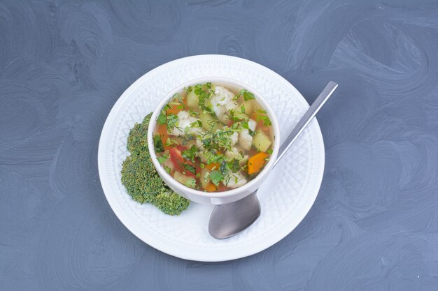 Green broccoli soup in broth with vegetables