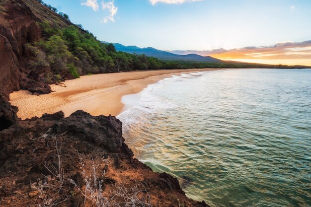 Green and Brown Mountain Beside Body of Water