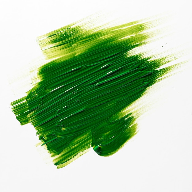 Зеленый мазок кисти на белом фоне
