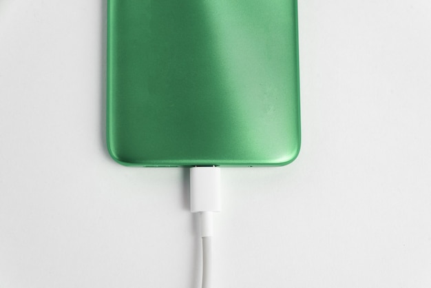 USB 케이블 유형 C에 연결된 녹색 휴대폰 - 충전 중