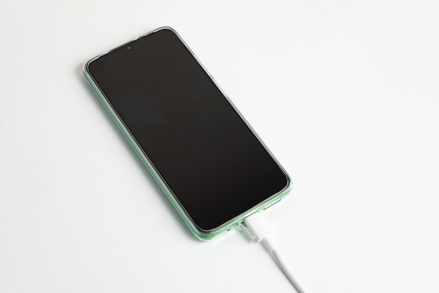 Green cell phone connected to USB cable type C - Charging