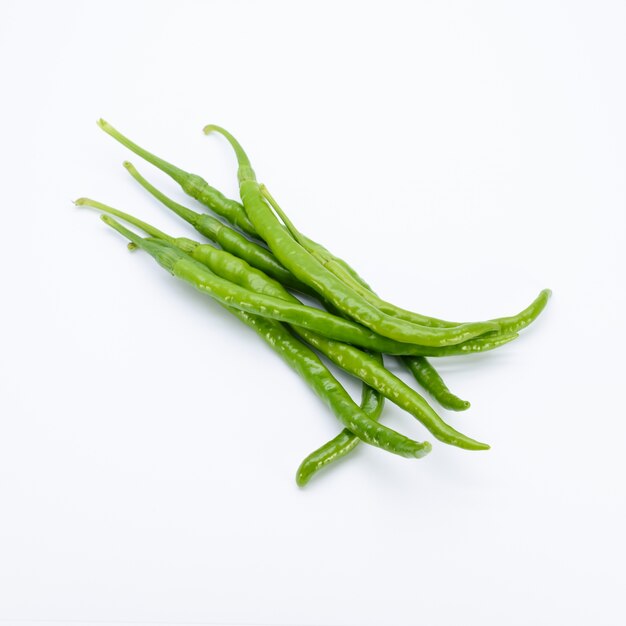 Green chillies on white background