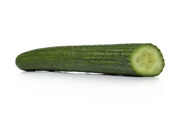 Green cucumber on a white surface