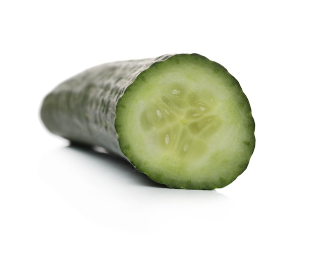 Green cucumber on a white surface