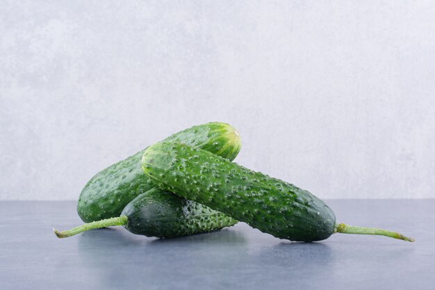 Green cucumbers isolated on blue surface