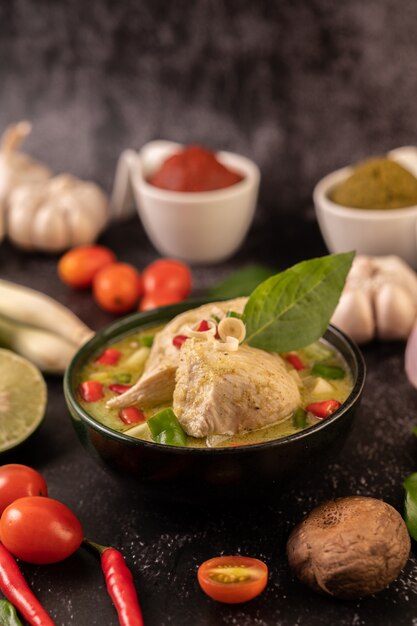 Green curry made with chicken, chili, and basil, with tomato, lime, kaffir lime leaves and garlic.