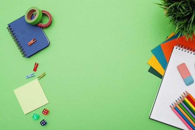 Green desk with stationery, top view, copypace