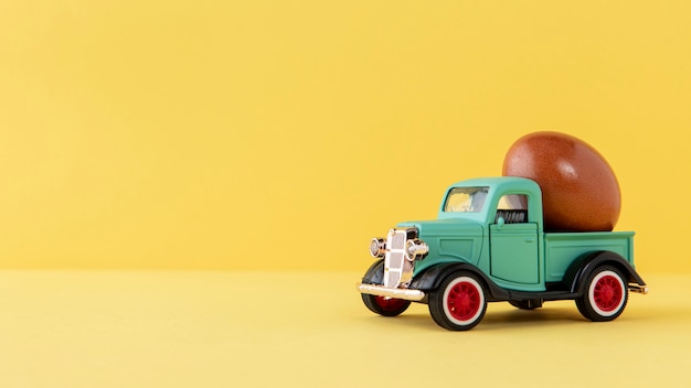Green easter car with brown egg and copy space