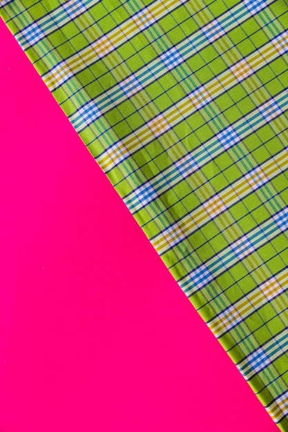 Free photo green fabric material on pink background