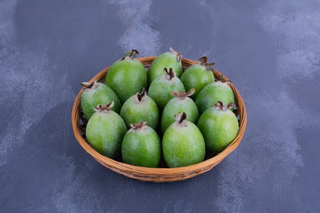 파란색 미니 컵에 녹색 feijoas.