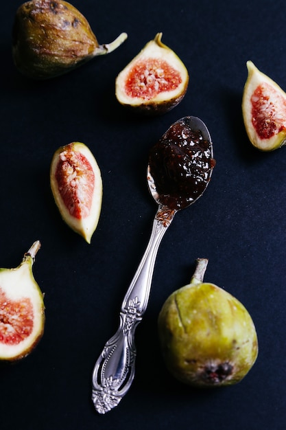 Green fig with jam on dark