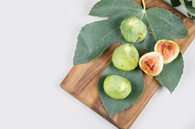 Green figs isolated with green leaves. 