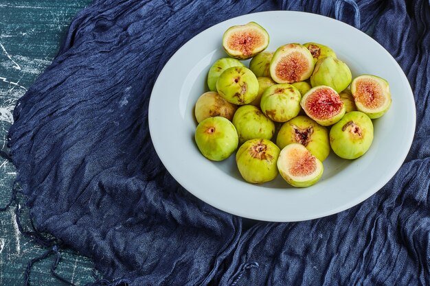 Green figs in a white plate. 