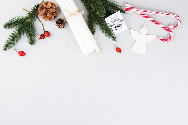 Green fir tree branches with candles and candy canes