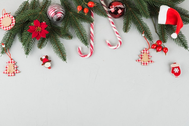 Green fir tree branches with candy canes and small toys