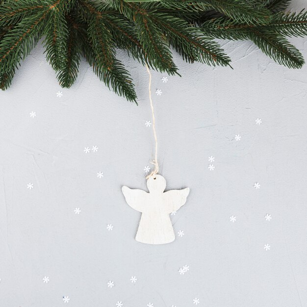 Green fir tree branches with small angel 