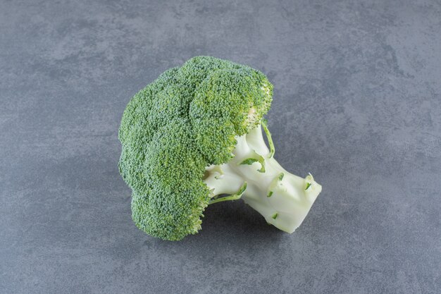 Green fresh broccoli isolated on blue surface