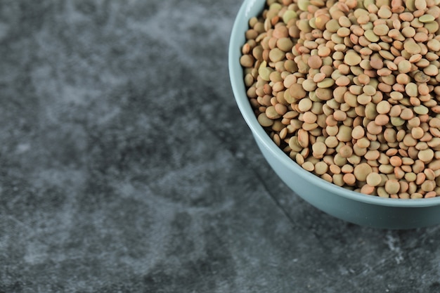 Green fresh and healthy lentil in a blue bowl