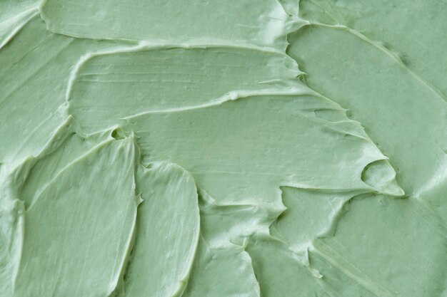 Green frosting texture background close-up