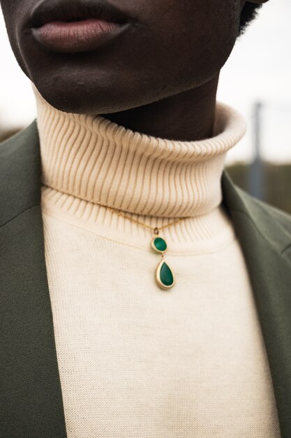 Green gemstone pendant on woman's neck