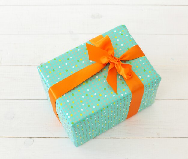 Green gift with orange bow