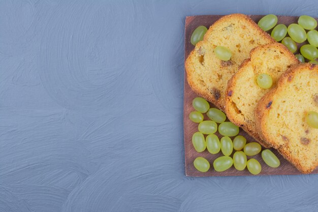 Green grape pie sliced on a wooden platter