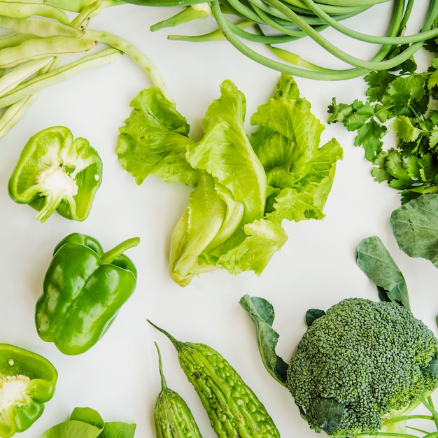 Free photo green healthy vegetables on white backdrop