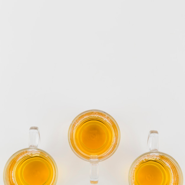 Green herbal glass tea cups on white background