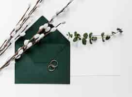 Free photo green invitation card with cotton branches