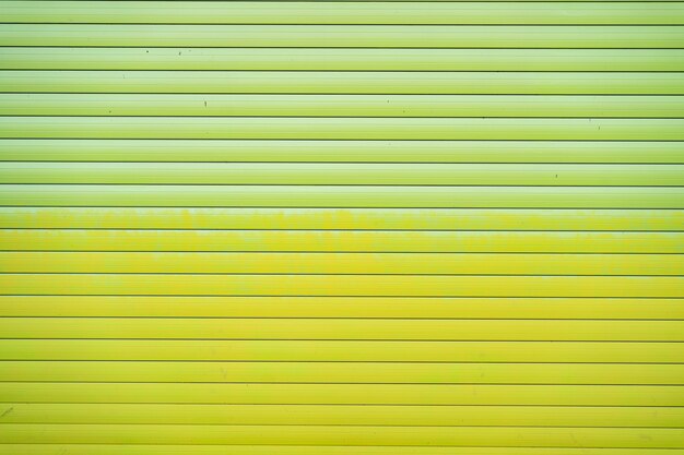 Green iron tin fence lined background. Metal texture