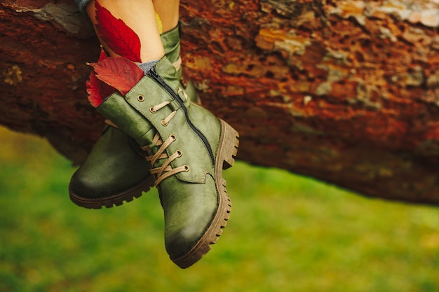 Green leather boots on women legs