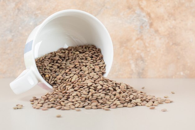 Green lentil beans on the concrete.