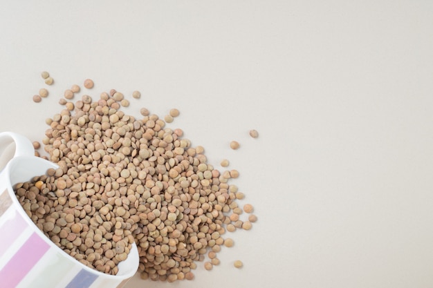 Green lentil beans isolated on concrete.