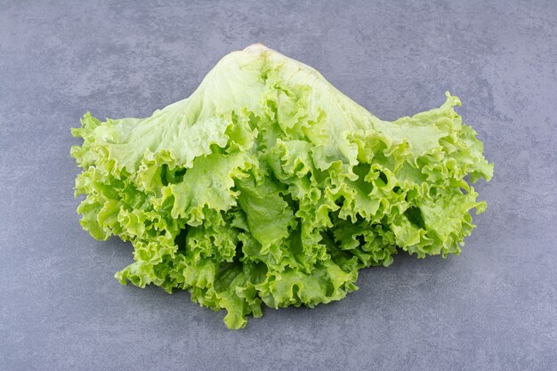 Green lettuce isolated on concrete background.