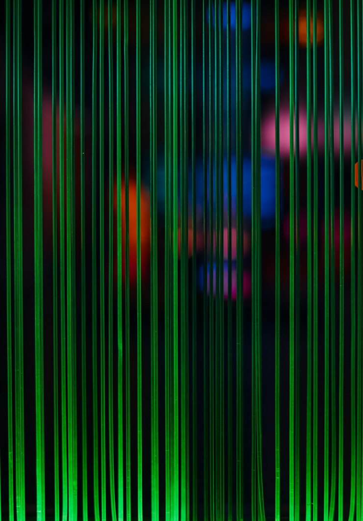 Free Photo green light lines and colored spots from fiber optic wires, computer communications idea, selective focus, blur, dark background, vertical frame