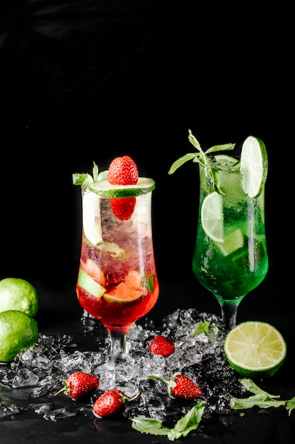 Green lime mojito with mint and red berry cocktails.