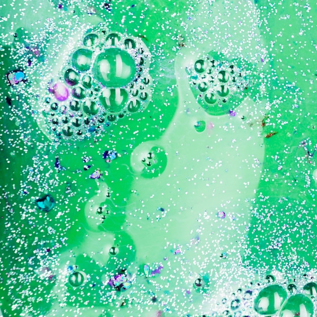 Green liquid with silver crumbs