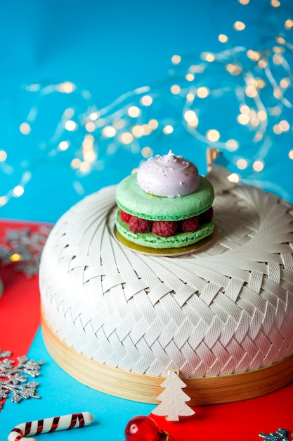 Free photo green macaroons with raspberries and meringues on top