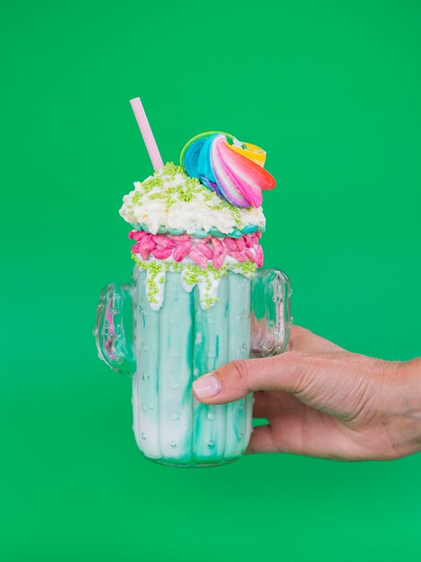 Green milkshake on green background