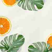 Free photo green monstera leaves and orange background