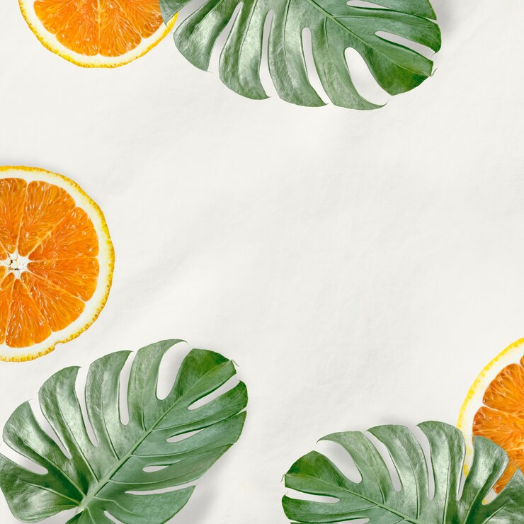Free Photo green monstera leaves and orange background