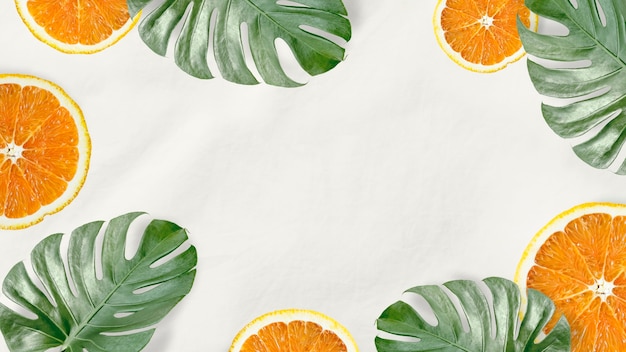 Free photo green monstera leaves and orange