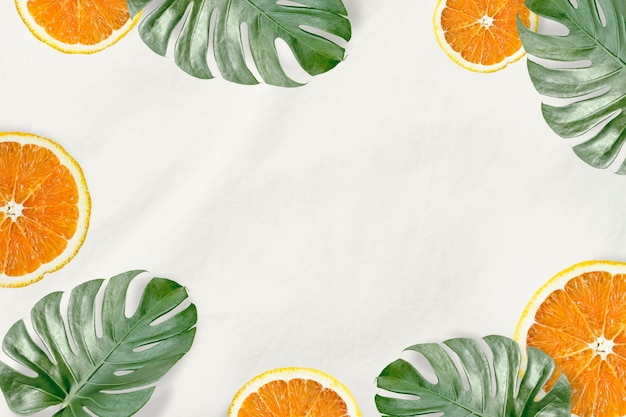 Free photo green monstera leaves and orange