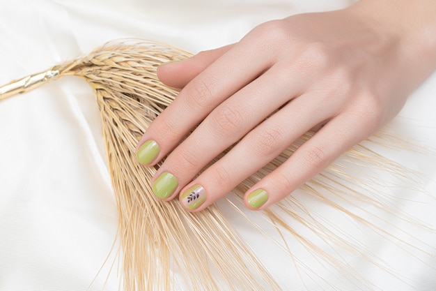 Green Nail Design: Female Hand with Glitter Manicure